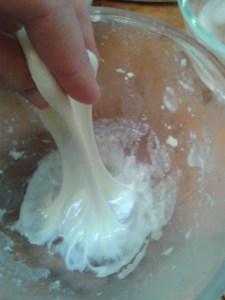 Home-made buffalo mozzarella stretching the curds